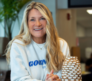 Susan, co-founder of Goodness Bowls, smiling confidently indoors.