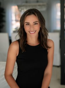 Smiling woman in black tank top portrait indoors - SMB Franchise Advisors