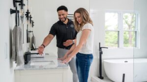 design professional and client - man and woman - looking at designs