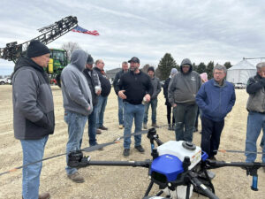 Farmers observing drone technology demonstration in agricultural field - SweetWater Technologies franchisees and techs.